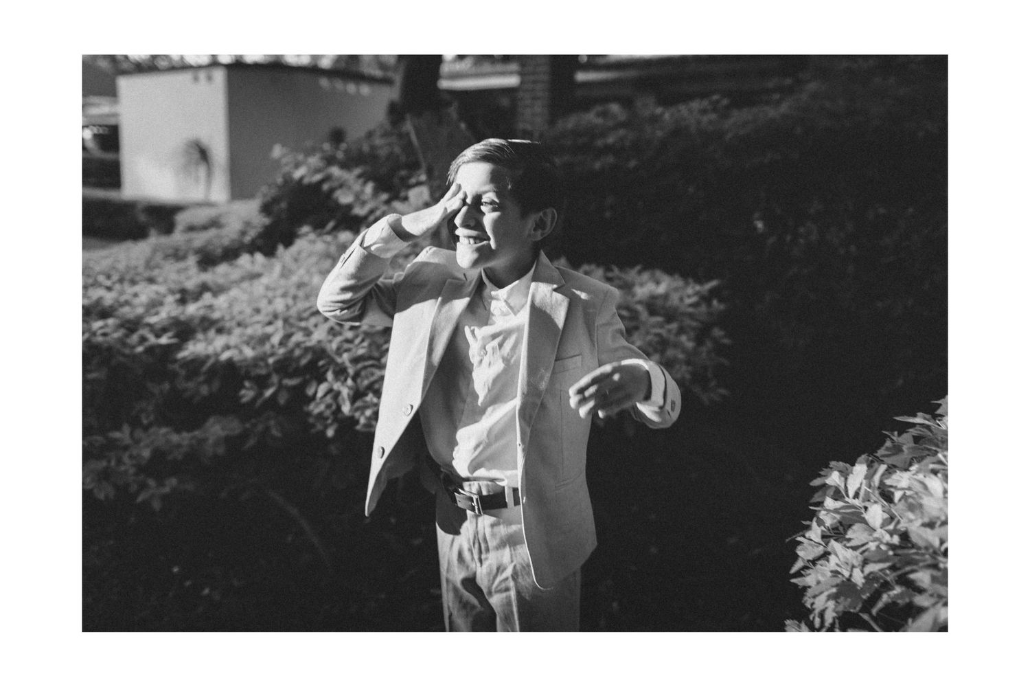 A series of black and white candid outdoor photos showing joyful emotions and natural interactions in a garden setting.