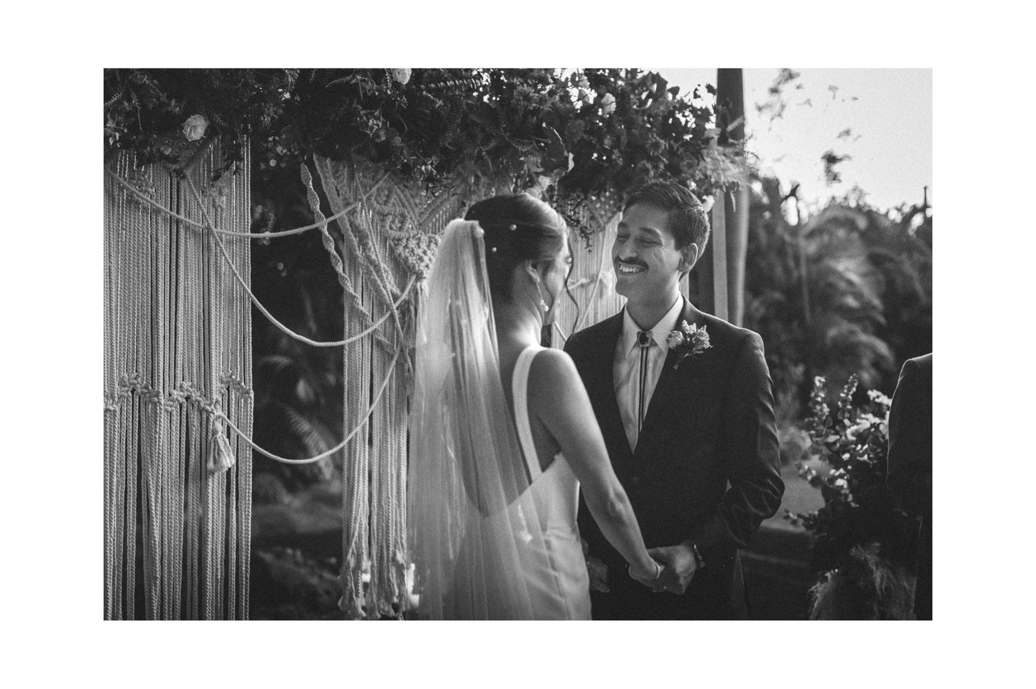 Black and white wedding photos show celebration with newlyweds, guests, and ceremony setting in an intimate venue.