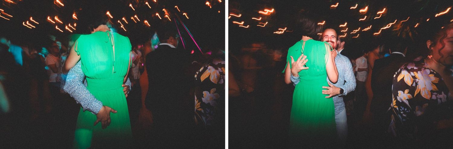 Couple dances together with lively green lighting at a wedding party celebration.