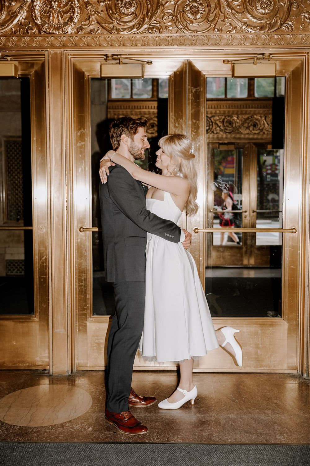 A romantic dance sequence showing spinning and twirling movements in an elegant hallway with classic architectural details.