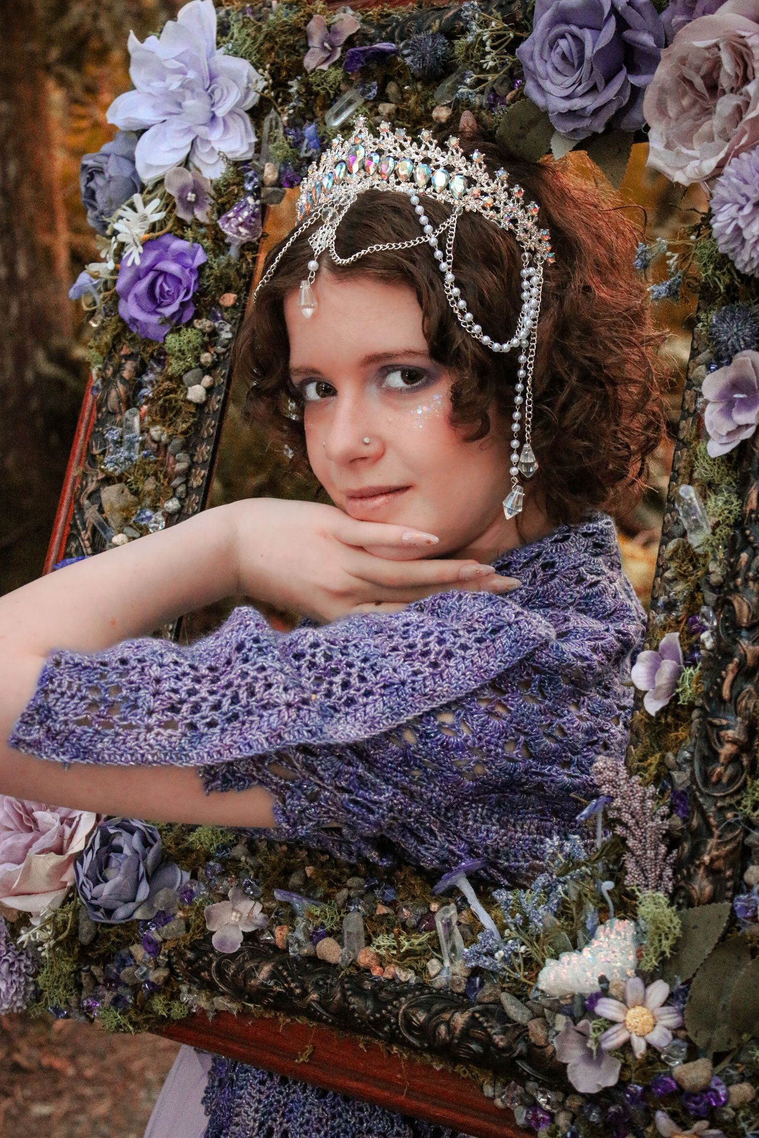 Ethereal fantasy portrait series featuring purple flowers, delicate headpieces and romantic styling against a natural backdrop.