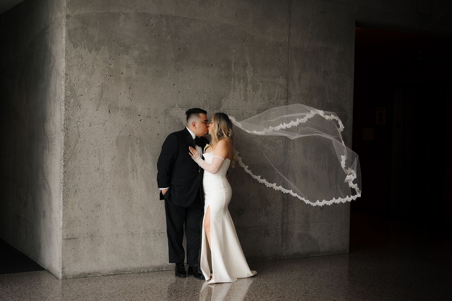 A romantic wedding photo series showing a couple in formal attire with the bride's veil flowing in multiple artistic poses.