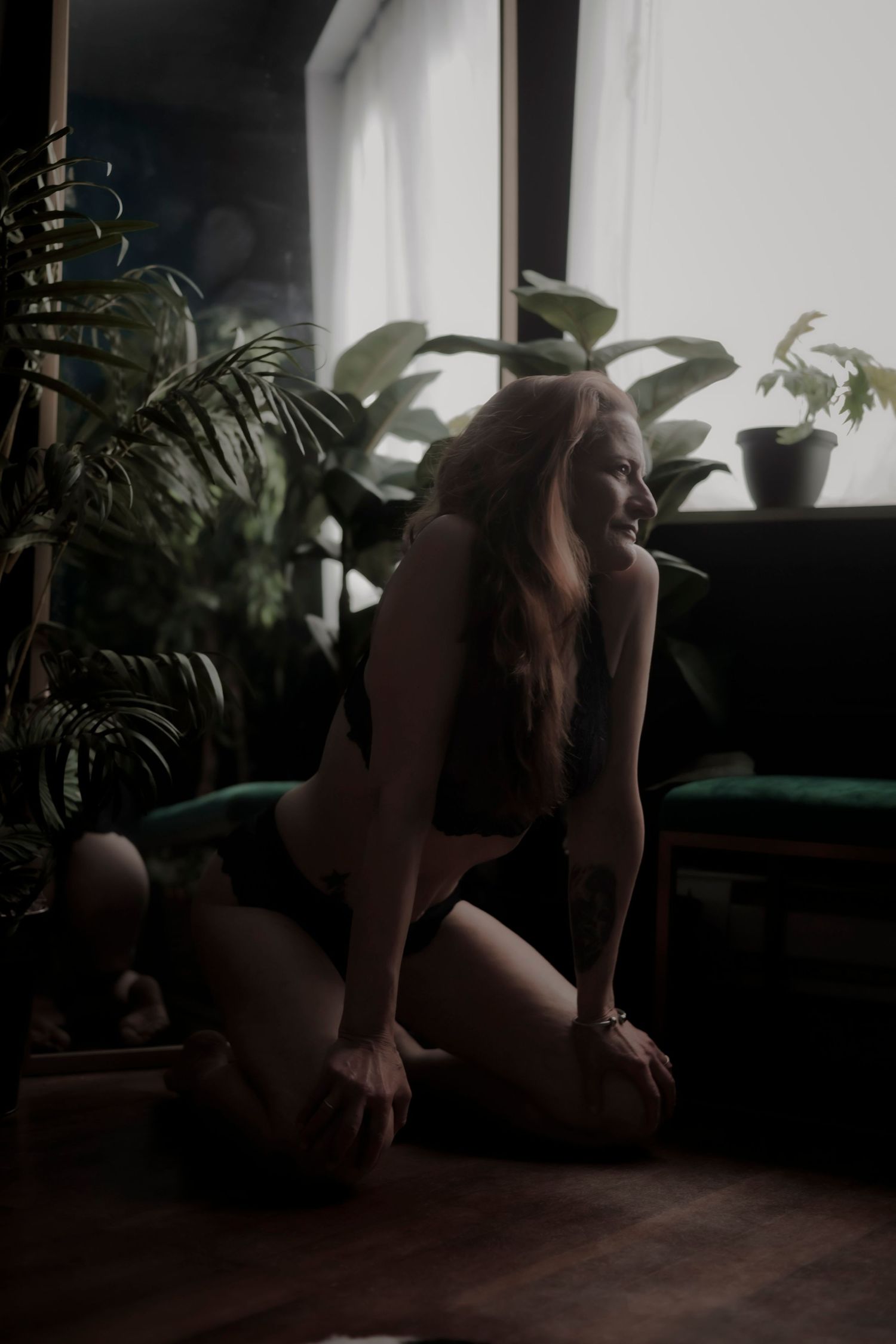 Black and white photographs arranged in a horizontal strip show intimate boudoir poses with romantic lighting and composition.