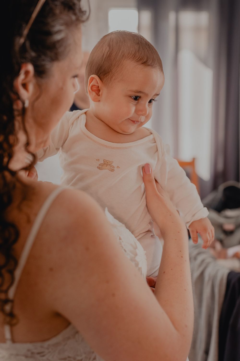 Tender moment captured during a baptism ceremony in natural light.