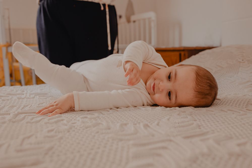 Peaceful moment captured on white bedding in natural light.
