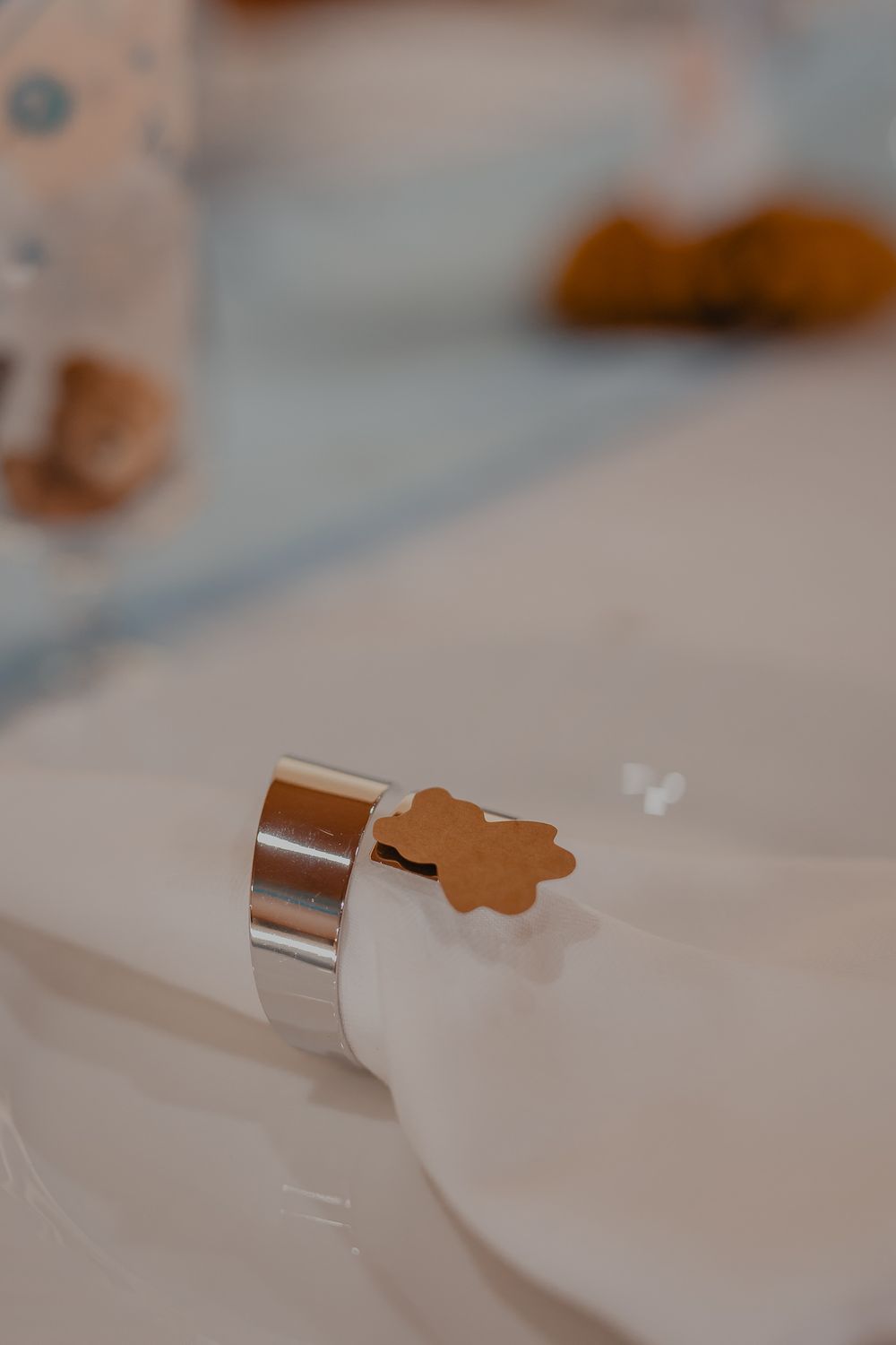 Small brown decorative items arranged on a white surface with soft focus.