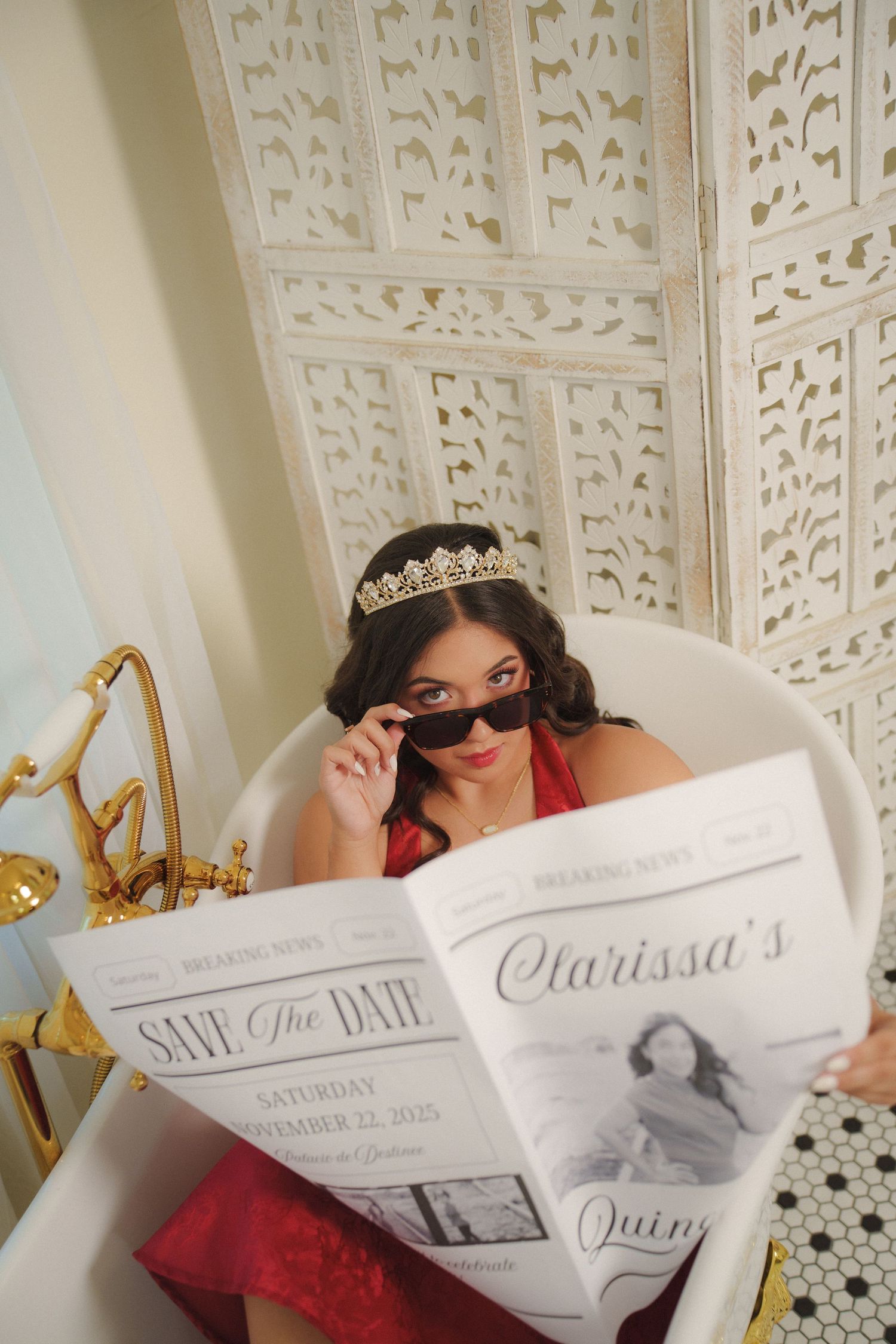 Playful photo shoot featuring save the date cards and sunglasses in a decorative bathroom setting.