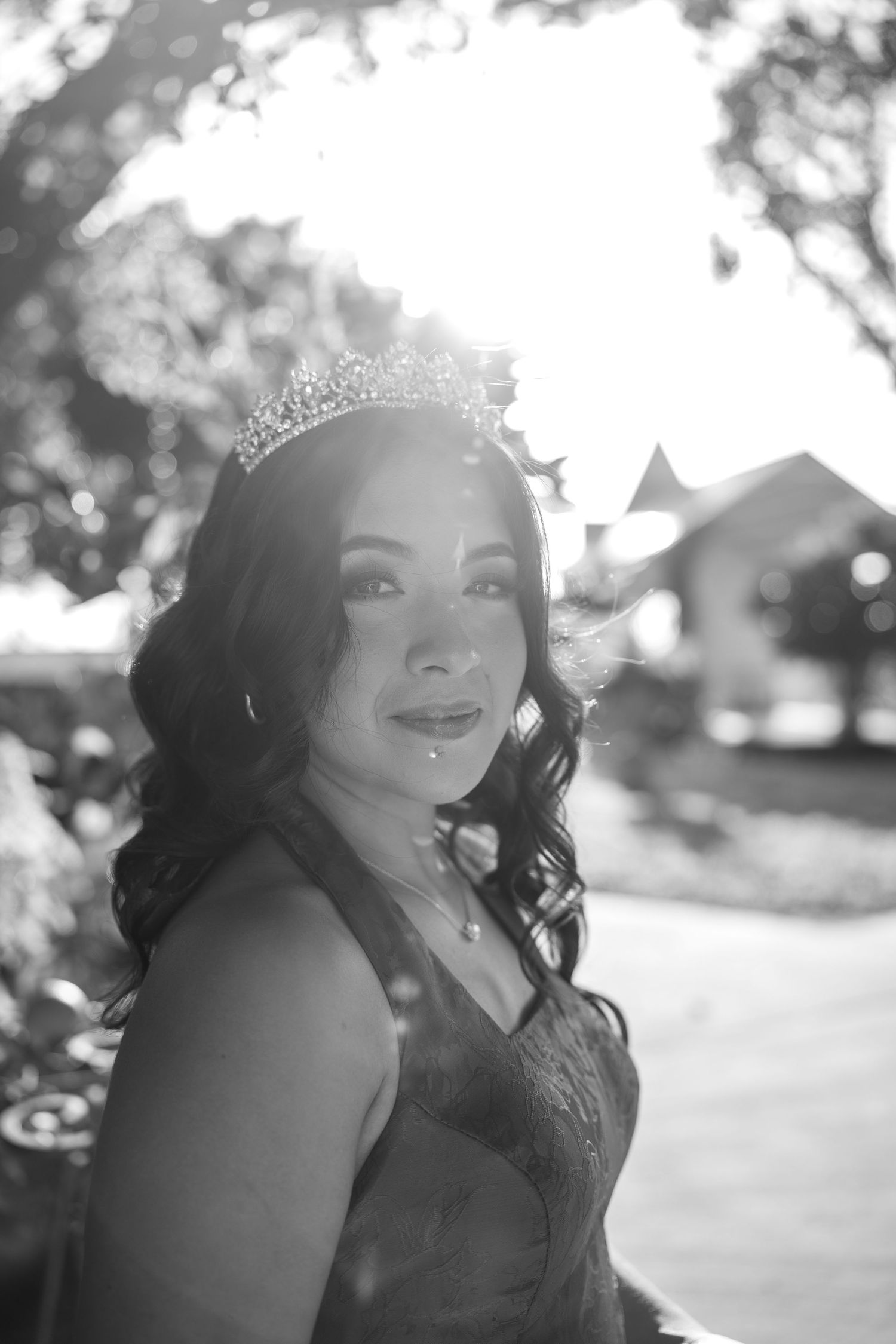 Black and white outdoor portrait with natural lighting and a sparkly tiara.