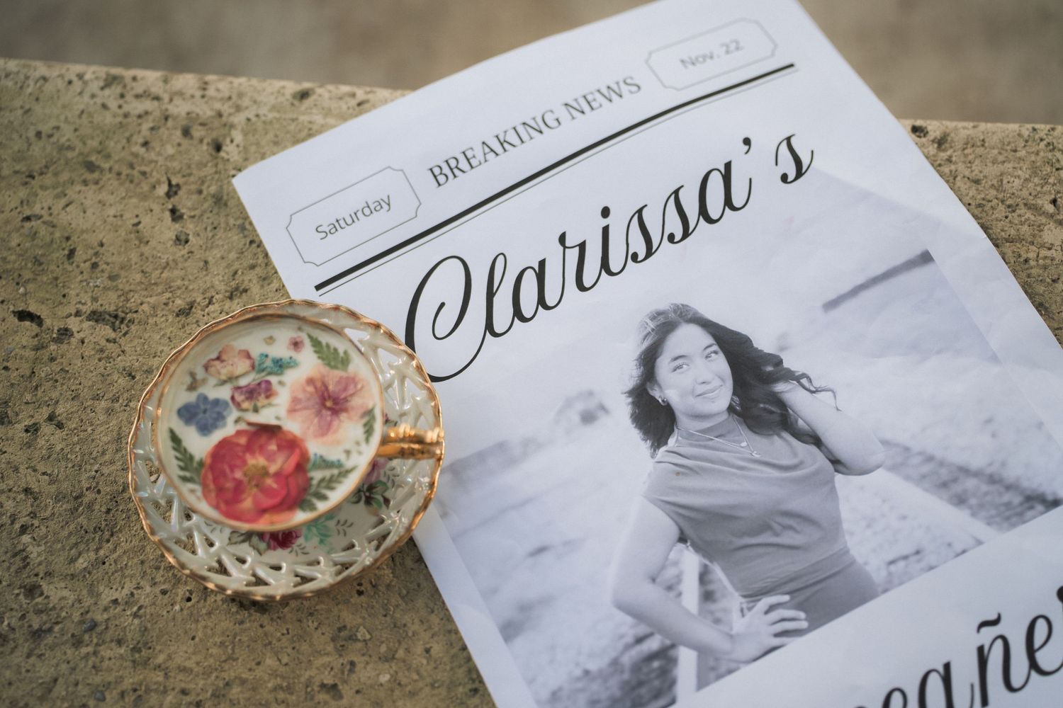 Professional photography prints and materials laid out on a textured concrete surface.