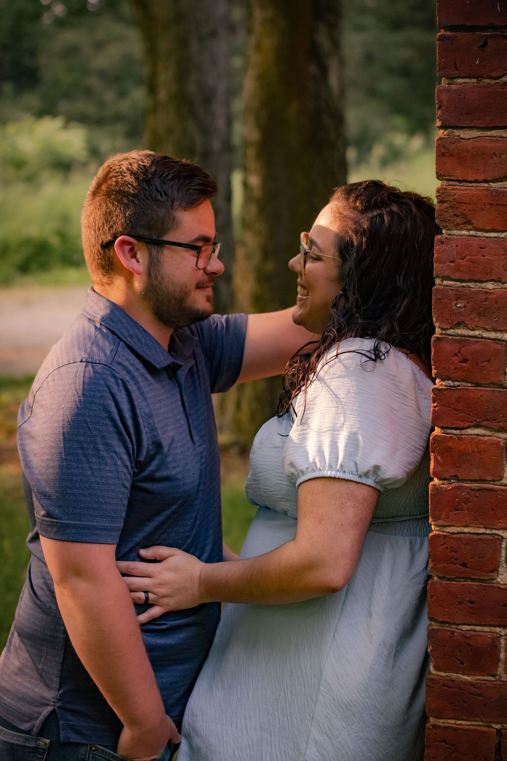 A romantic sequence of photos shows a couple sharing joyful embraces and laughs against a brick wall outdoors.