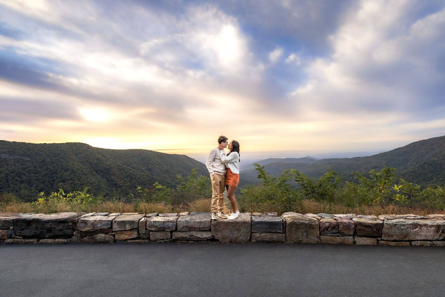 A series of panoramic mountain views with cloudy skies and scenic overlooks along a coastal landscape.