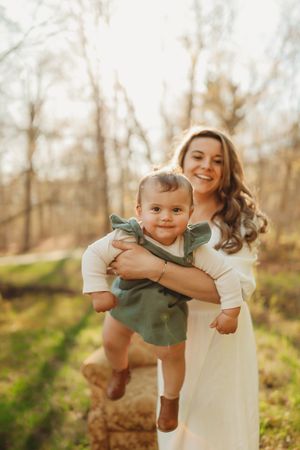 Candid outdoor portrait in wooded setting with natural lighting.