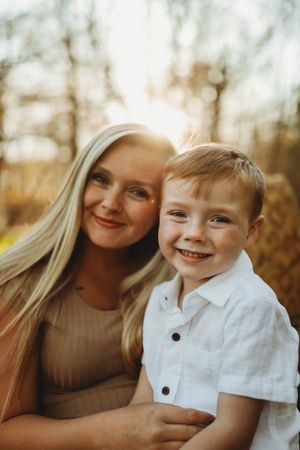 Sweet portrait in golden autumn sunlight against natural background.