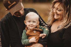 Happy family moment captured in warm autumn lighting outdoors.