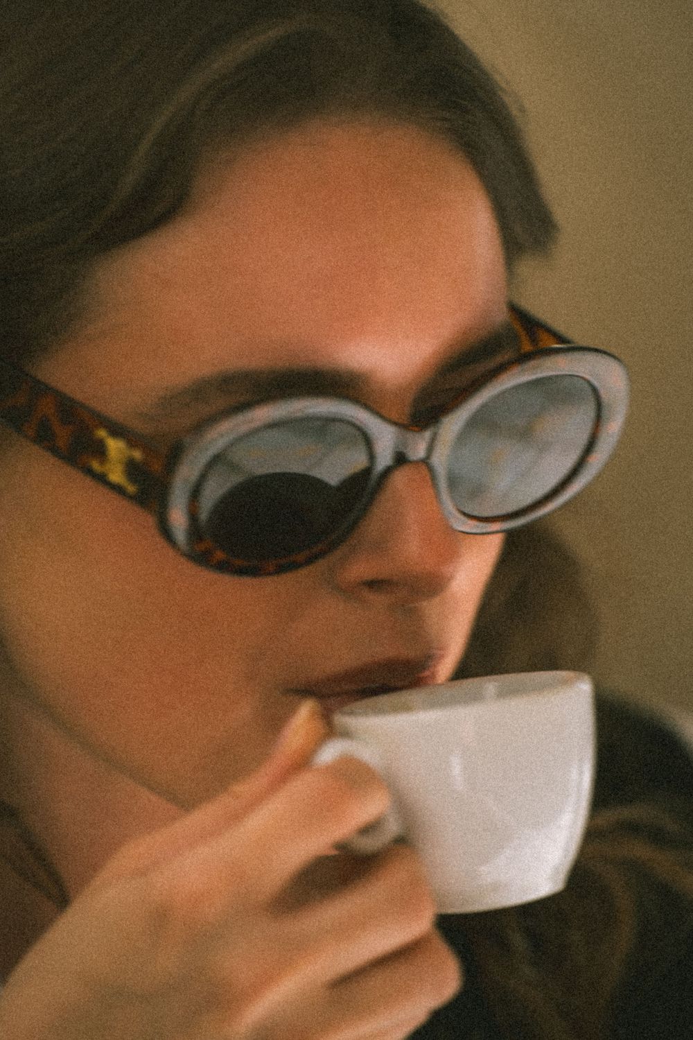 Girl sipping coffee in Palermo Sicily, captured by a photographer in Palermo