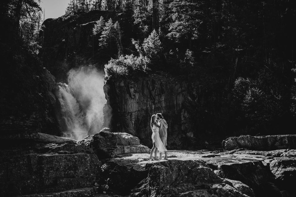 Couple adventure photoshoot session at Myra Falls on Vancouver island taken by professional photographer of couple dancing by waterfall