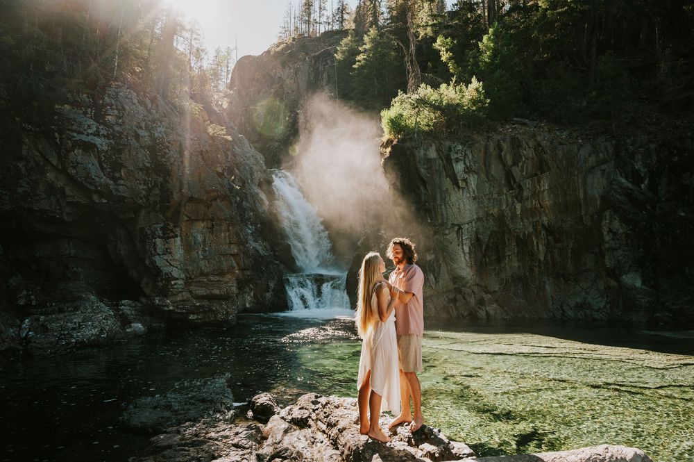 Couple adventure photoshoot session at Myra Falls on Vancouver island taken by professional photographer of couple dancing by waterfall