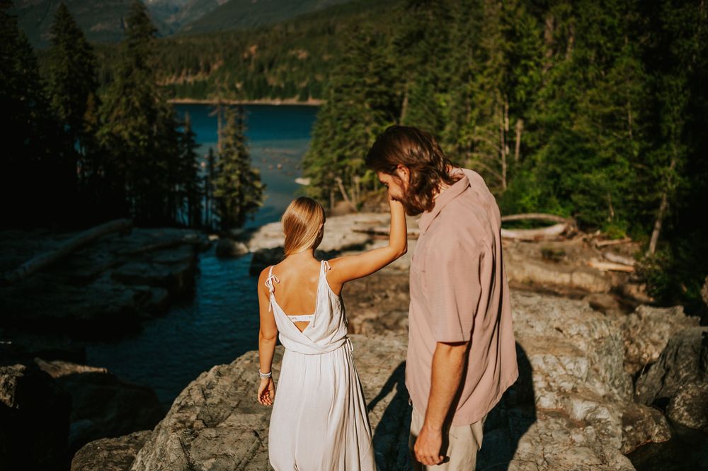 Couple adventure photoshoot session at Myra Falls on Vancouver island taken by professional photographer of couple walking down river