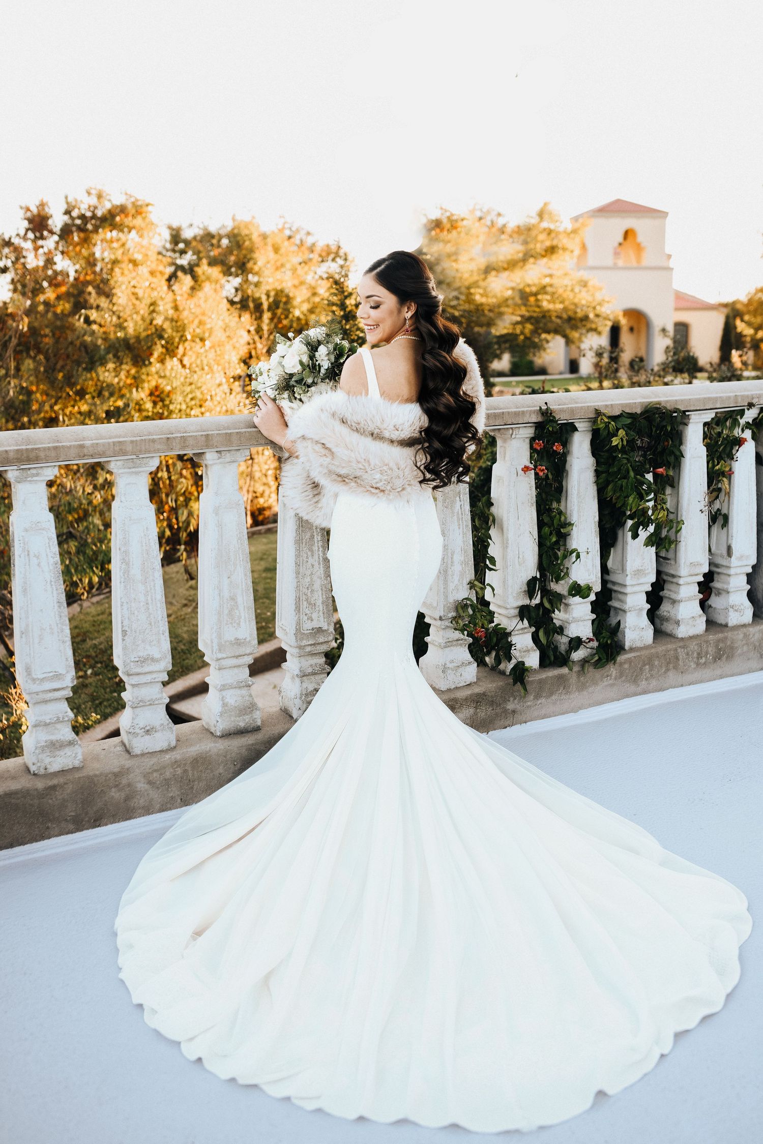 Bride on Mediterranean balcony overlooking Azle Texas countryside at sunset bridal session