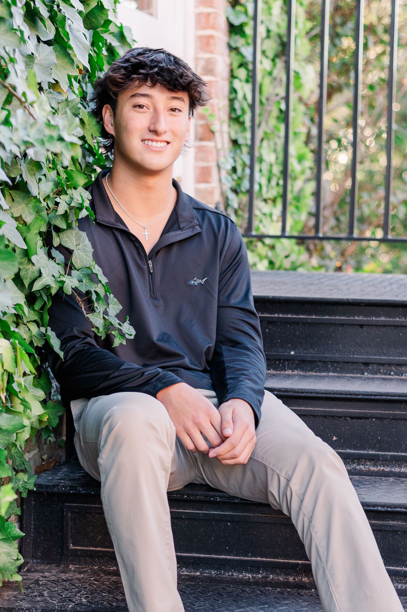 High school senior boy smiling, casual outfit, sitting on stairs, Senoia senior session