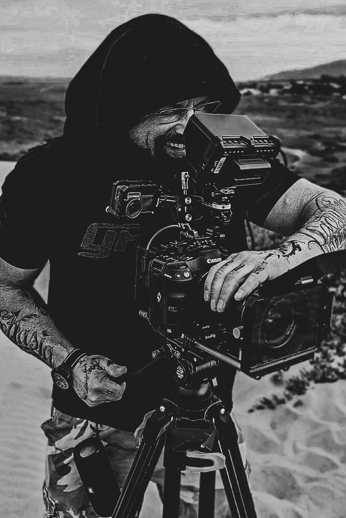 A series of black and white photographs showing hands holding professional video cameras against snowy landscapes.