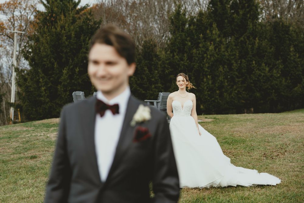 Romantic outdoor wedding portraits with evergreen trees creating a natural backdrop.