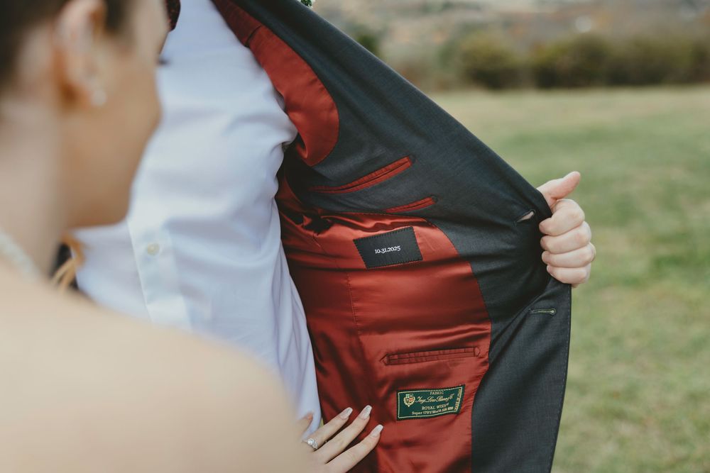 Close-up shots of someone holding and adjusting a burgundy and black backpack.