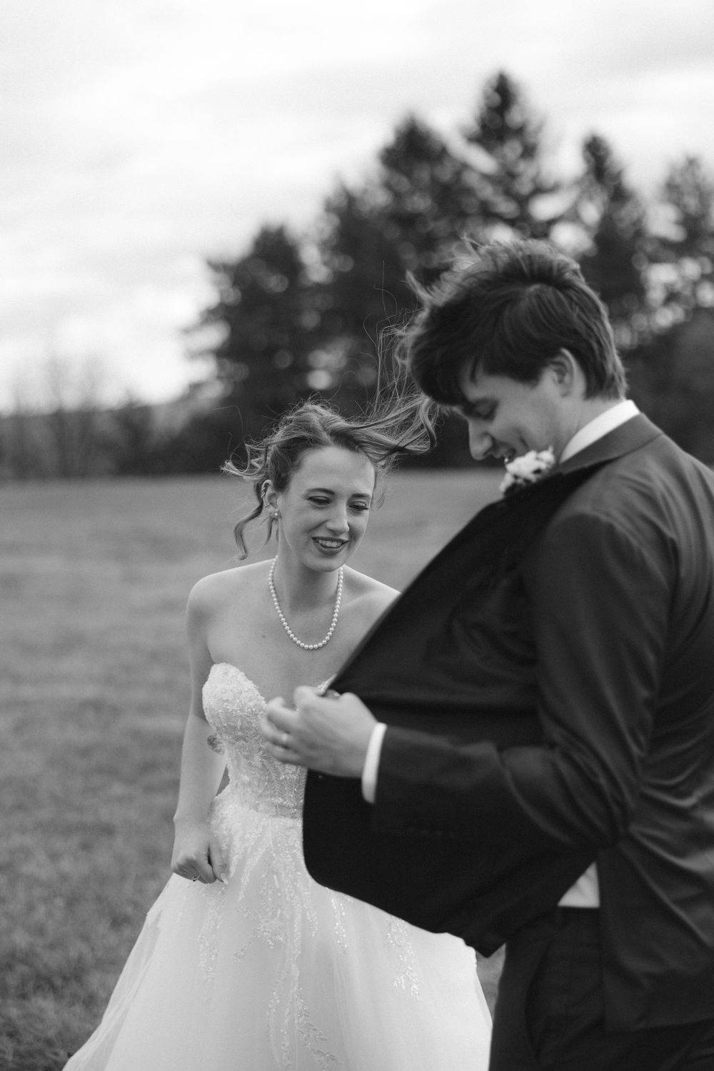 Black and white candid wedding photos showing laughter and genuine moments between newlyweds.