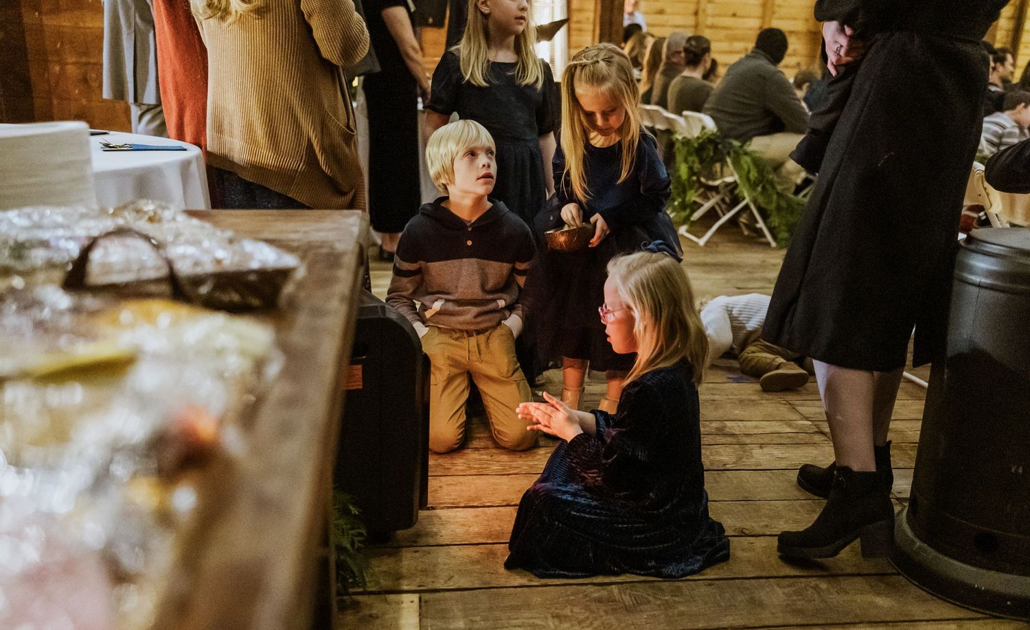 A few kids huddled around the heater during a wedding at Red Star Barn in Walla Walla