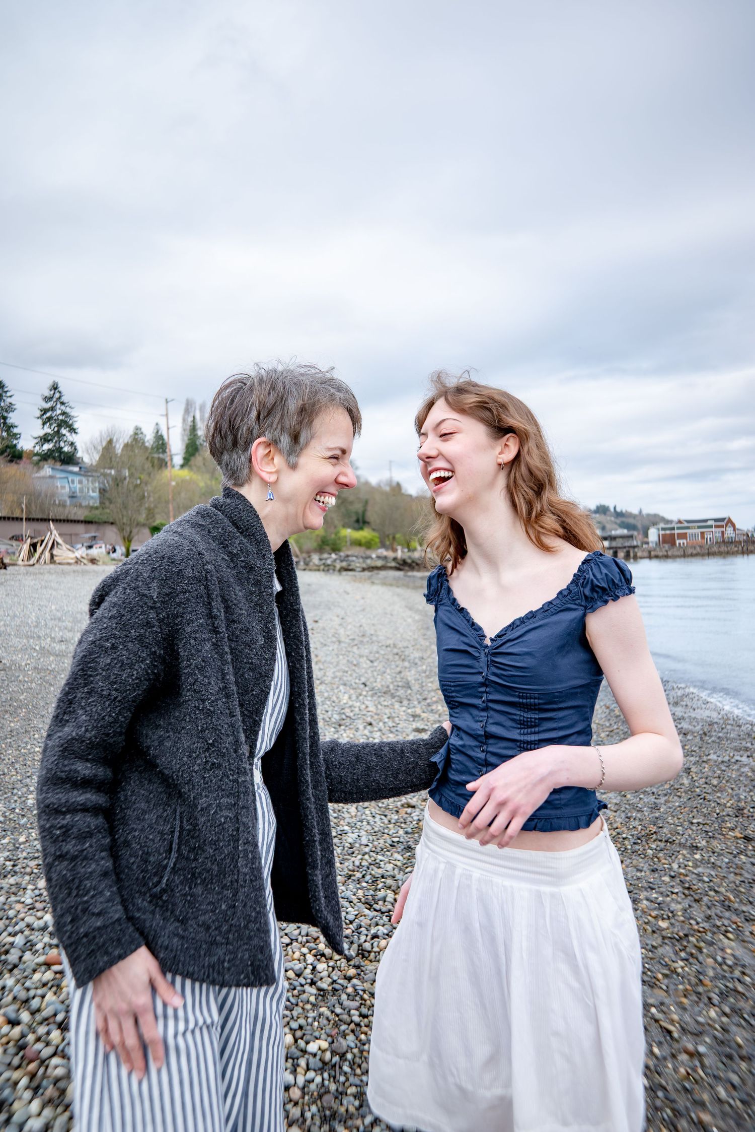 Natural laughing moment between a mother and daughter during Tacoma senior graduation photo shoot