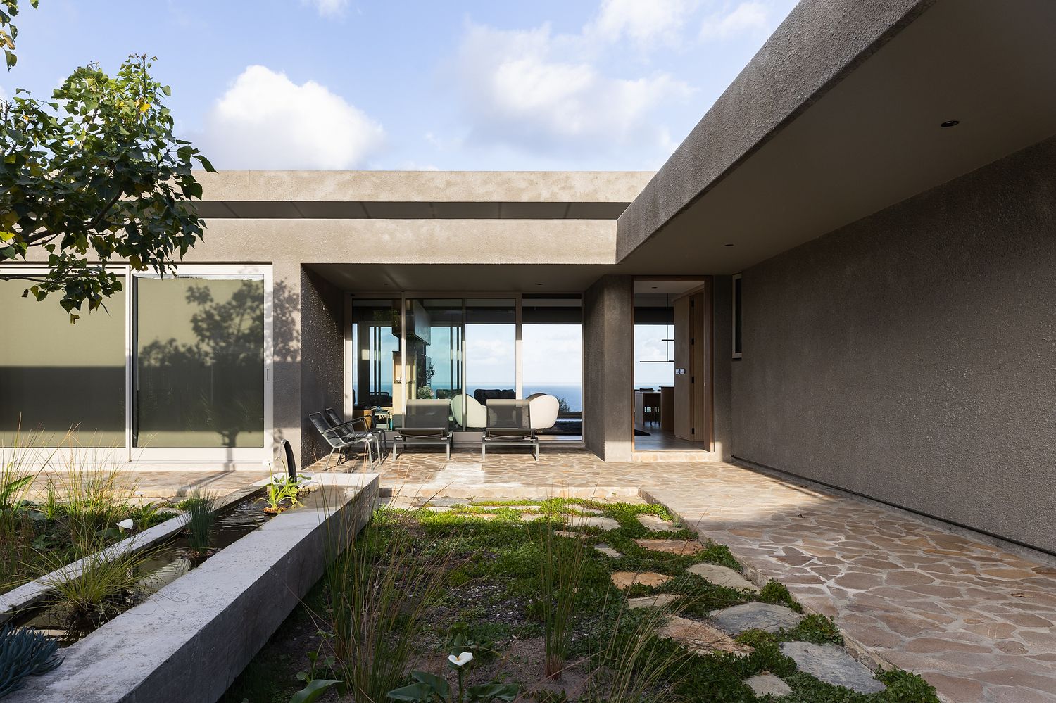 Contemporary luxury home overlooking the ocean with clean architectural lines and neutral tones