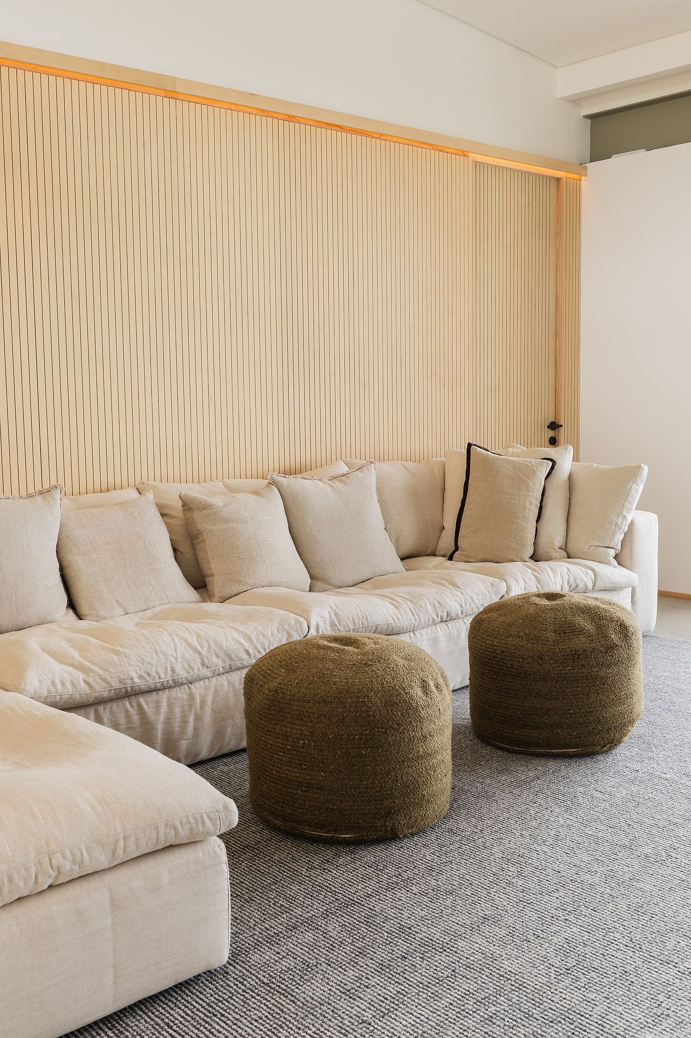 Contemporary interior with layered textures, linen sofas, and warm earthy tones