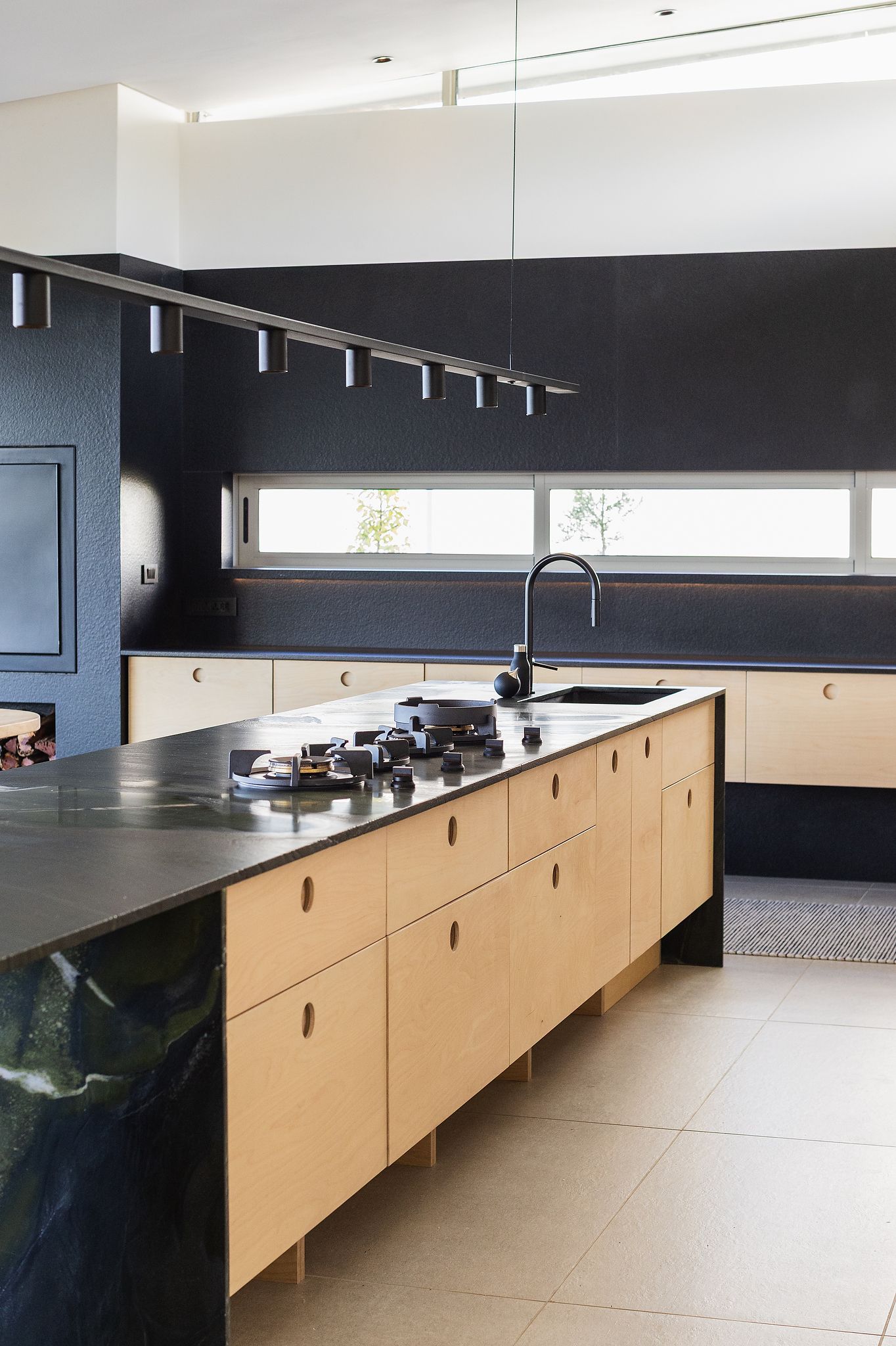 Modern kitchen with clean finishes, natural materials, and soft ambient lighting
