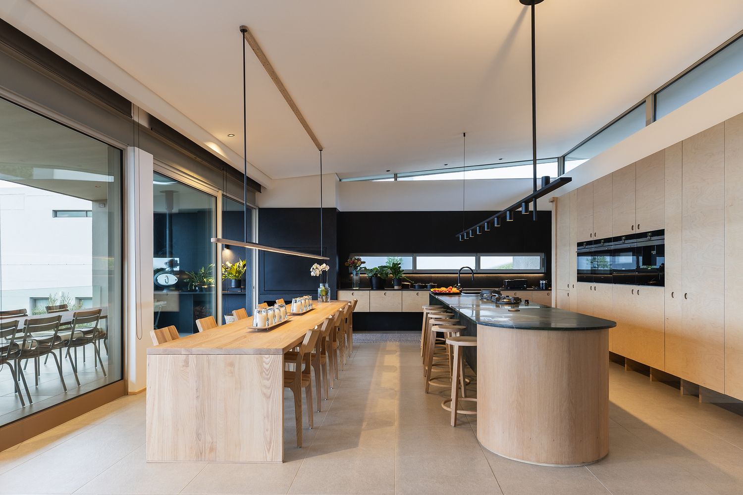 Open dining area with wooden table, neutral styling, and ocean-facing views