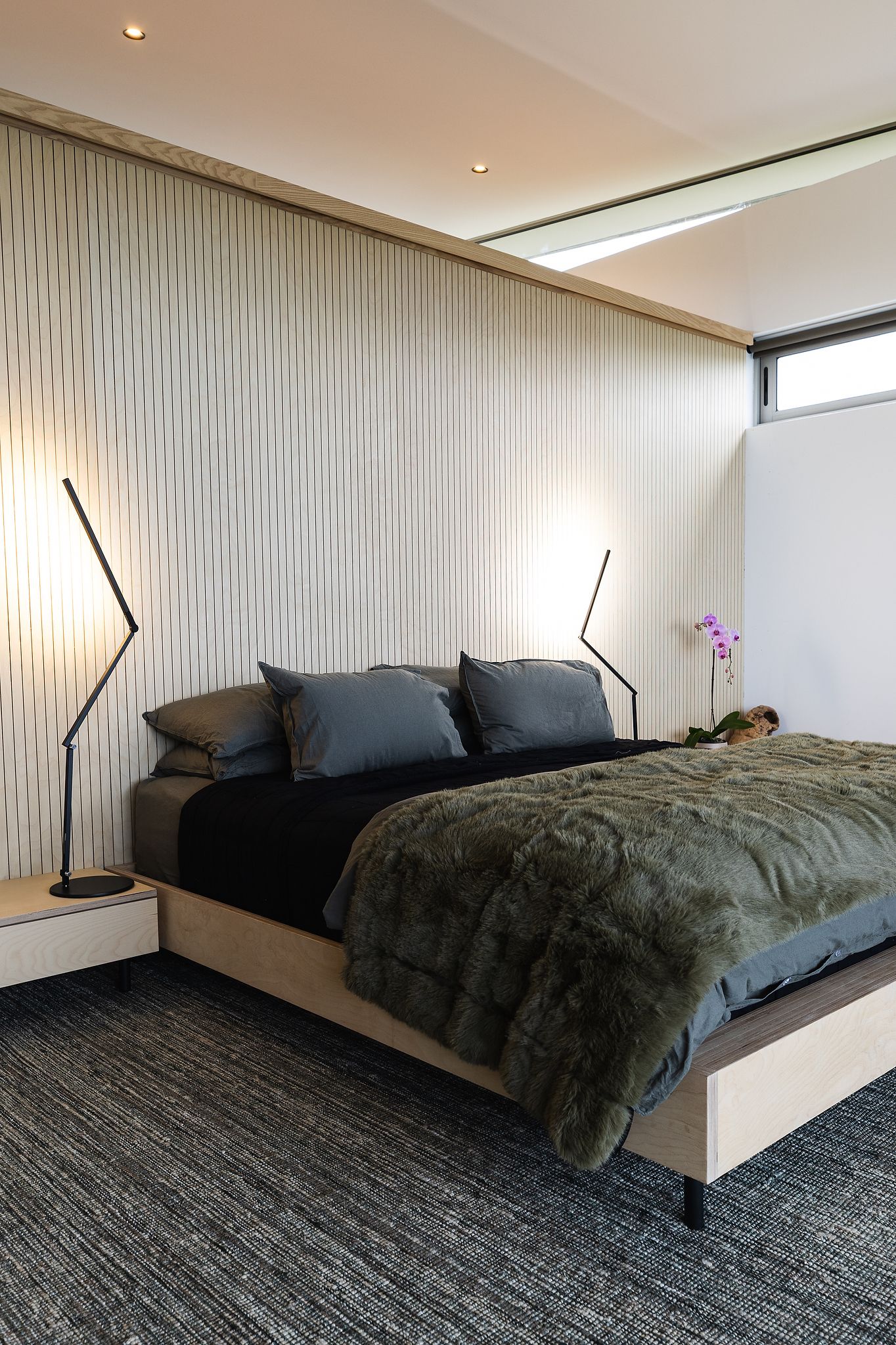Minimalist bedroom with soft linen textures and calming neutral palette
