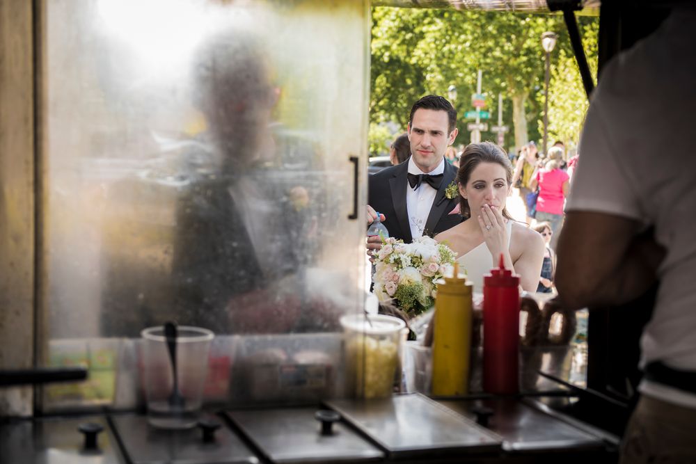 Restaurant kitchen staff preparing food at cooking stations during a busy dinner service.