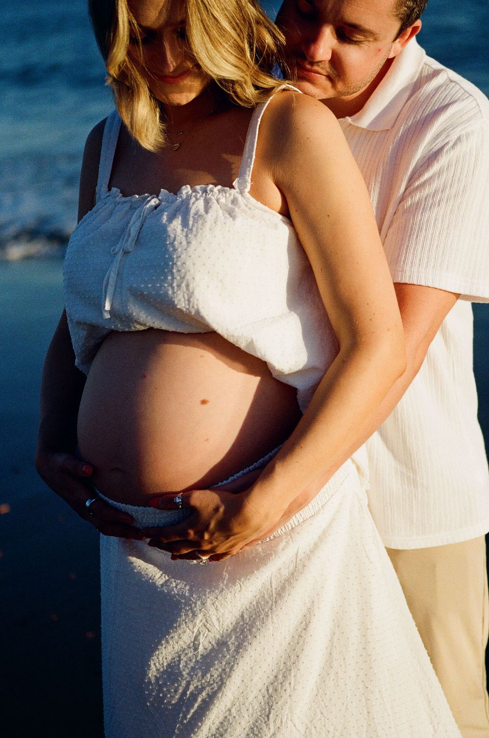 Artistic silhouette of an expectant mother against the dramatic coastline of a Santa Barbara location, emphasizing the film photography
