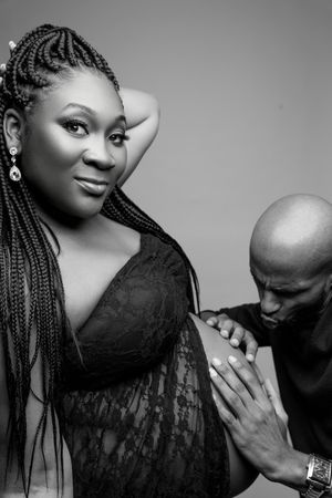 Black and white maternity portraits with dramatic lighting and black lace attire.