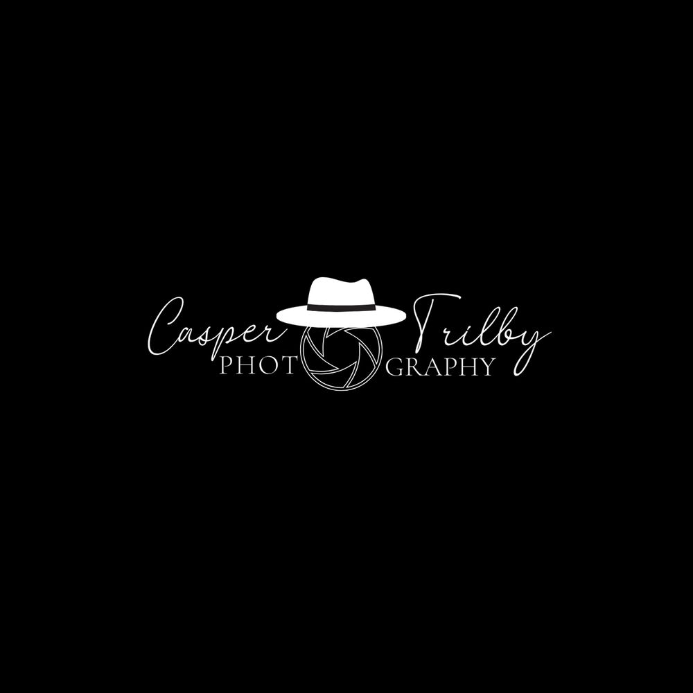 Black and white photography logo design with hat icon on dark background.