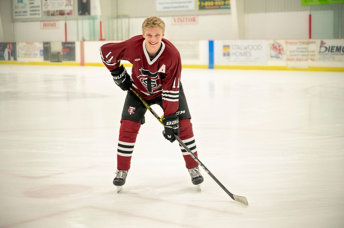 teen boy in hockey gear with hockey stick on the ice at Baltimore Community Centre, by Nicole Turk Photography*