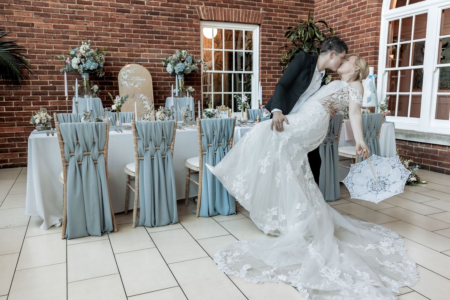 Documentary moment as bride and bride share a dip kiss moment.