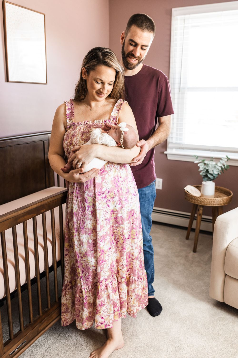 couple with new baby in nursery