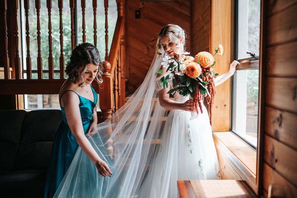 Maid of honour straightening out bride's veil during a Melbourne wedding day taken by a Melbourne wedding photographer.