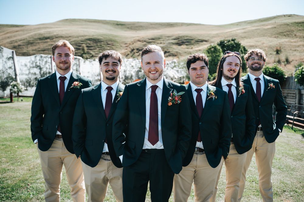 Portrait of the groom in the middle with his groomsmen taken by a Melbourne wedding photographer.
