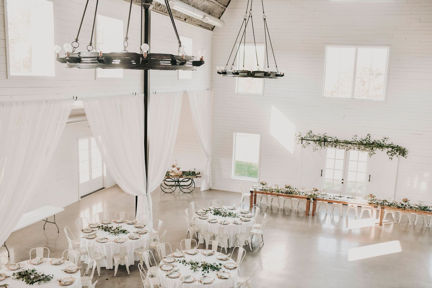 Wedding reception inside white barn at The Barn at Paradise