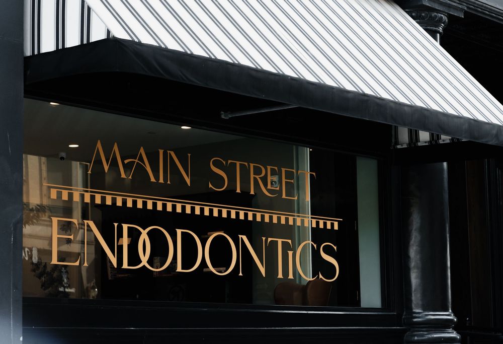 Black and white storefront awning with business signage.