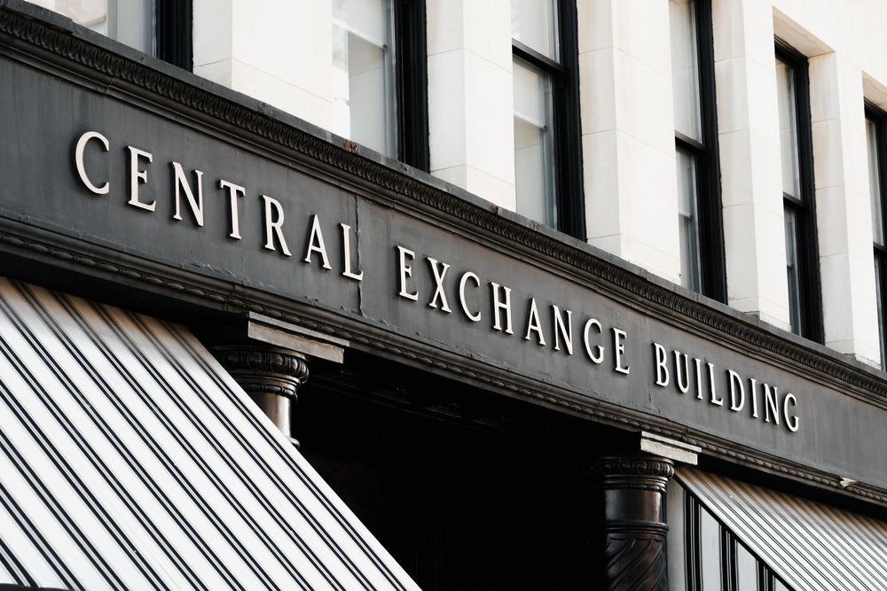 Modern commercial building exterior with Central Exchange signage and striped awnings.