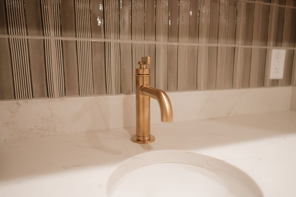 Textured vertical striped wall treatment in beige tones with modern lighting fixtures.