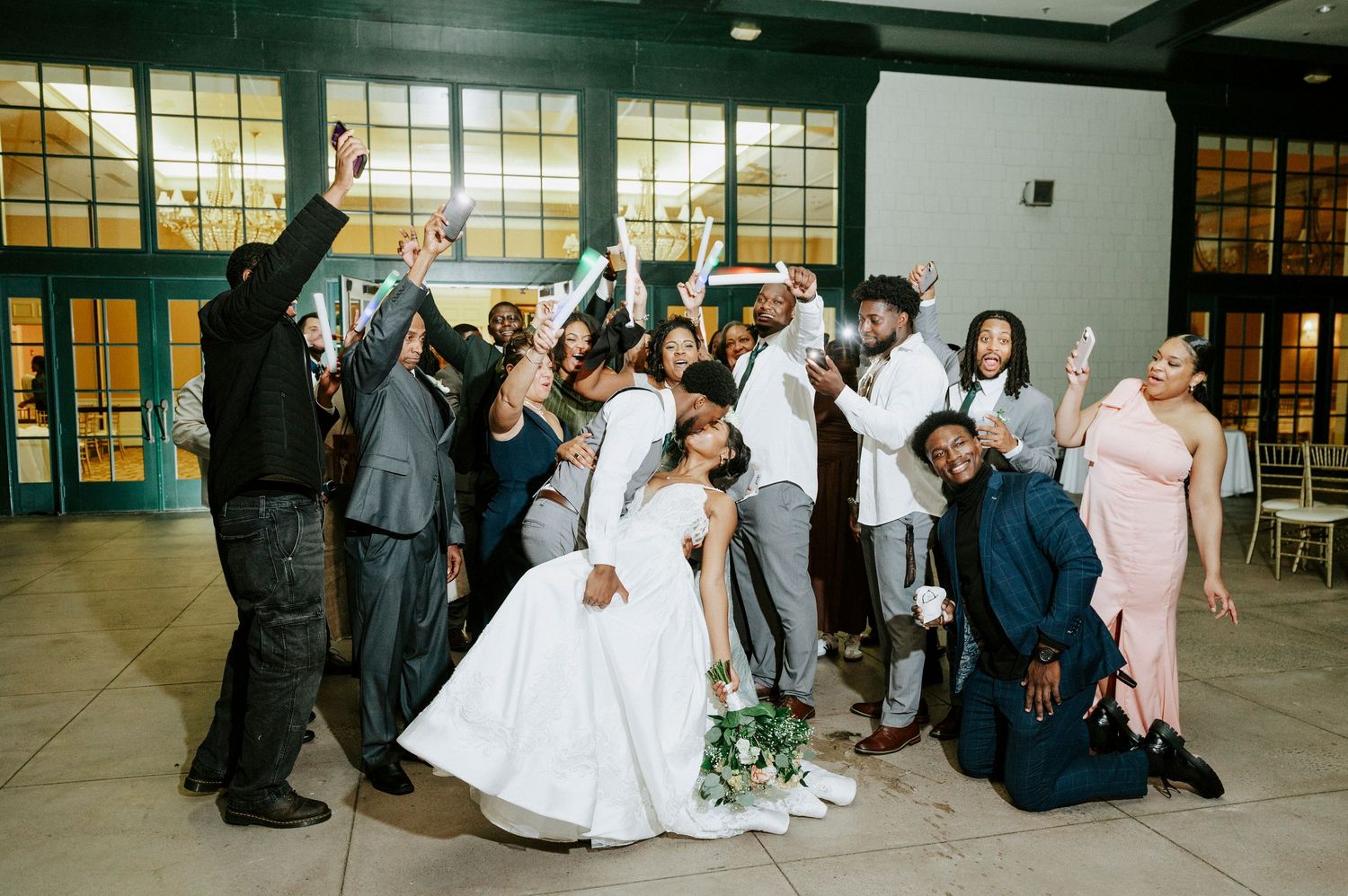 Wedding reception celebration with guests dancing and celebrating on the dance floor.