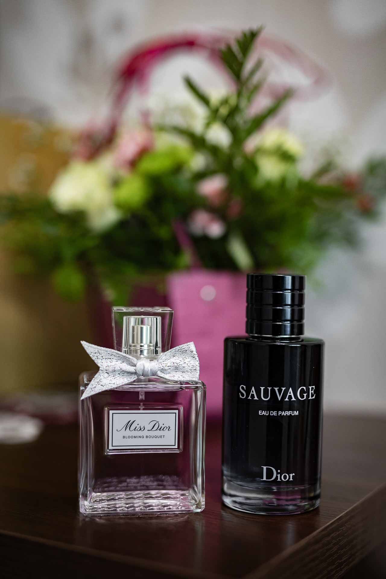 Dior perfume bottles including Sauvage and Miss Dior fragrances displayed on a table.